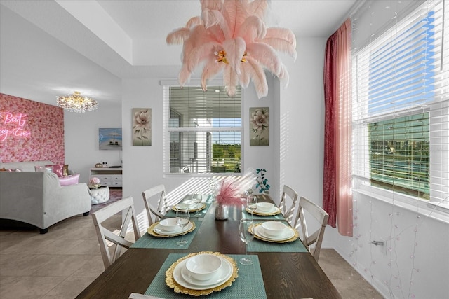 tiled dining space with a chandelier and a healthy amount of sunlight