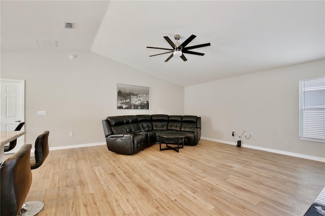 living room featuring ceiling fan, vaulted ceiling, and light hardwood / wood-style flooring