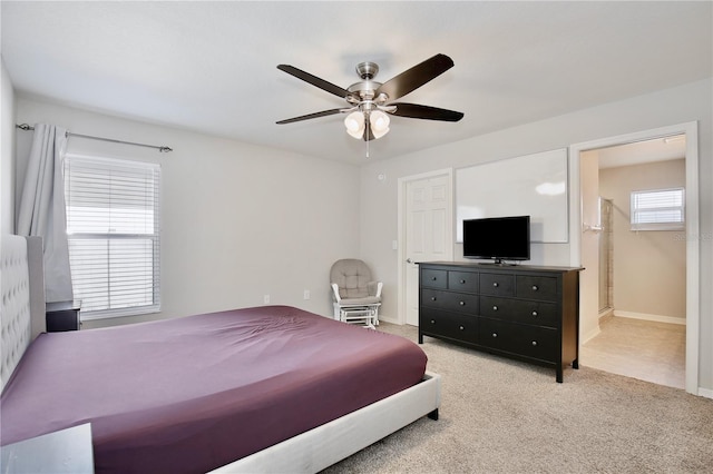 tiled bedroom featuring ceiling fan and ensuite bath