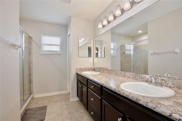 bathroom featuring double sink, tile flooring, vanity with extensive cabinet space, and walk in shower