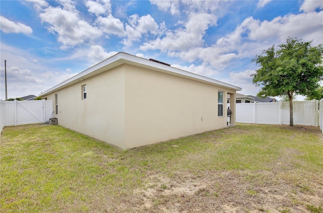 back of property featuring a lawn