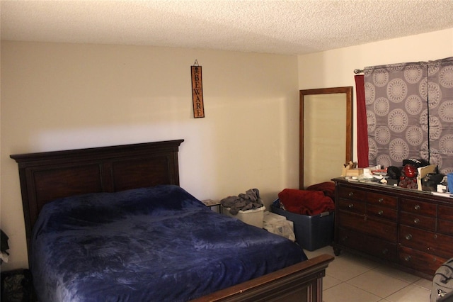 tiled bedroom featuring a textured ceiling