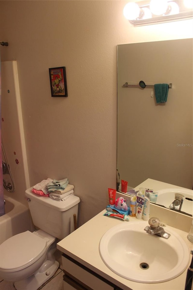 full bathroom featuring vanity, bathtub / shower combination, and toilet