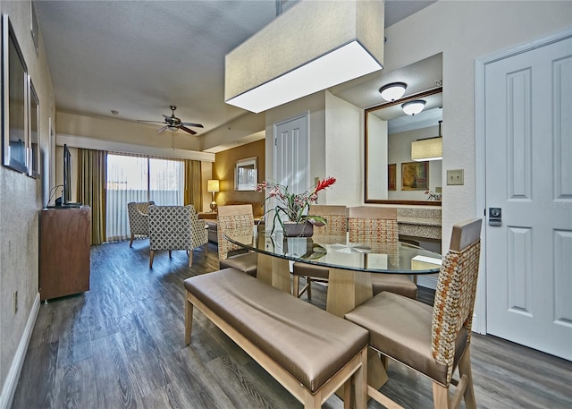 dining area featuring ceiling fan and dark hardwood / wood-style flooring