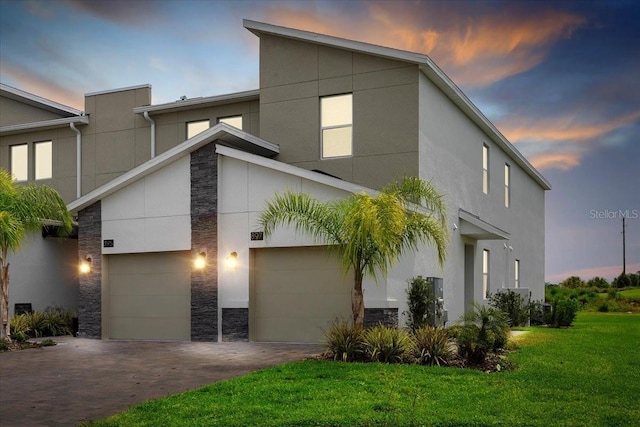 view of front of house with a lawn and a garage