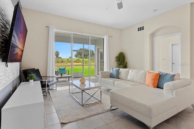 living room featuring ceiling fan and light tile floors