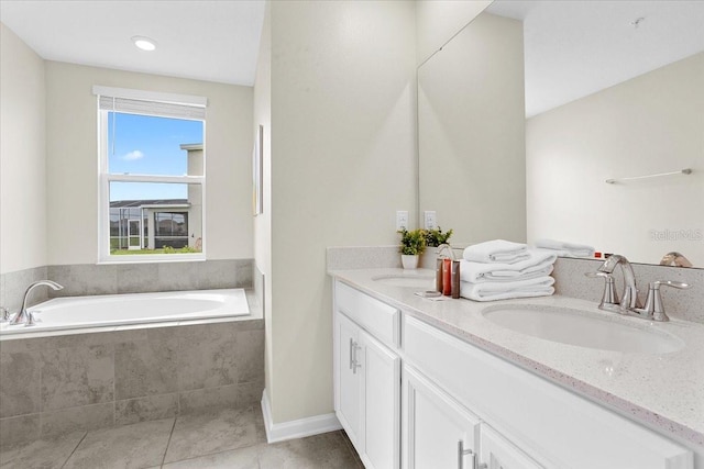 bathroom featuring tiled bath, tile floors, a healthy amount of sunlight, and dual bowl vanity