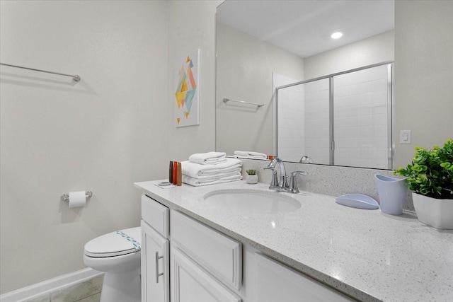 bathroom with tile floors, oversized vanity, and toilet