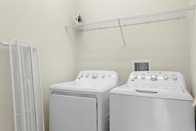 clothes washing area with washer and dryer and washer hookup