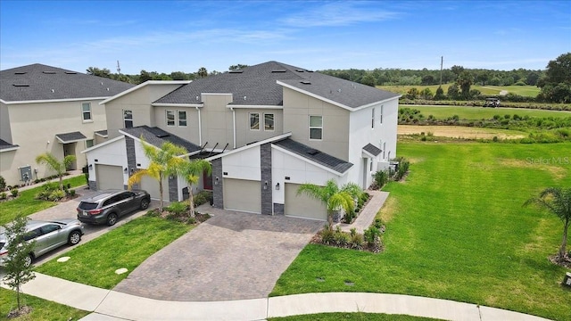 view of front of home with a front lawn and a garage