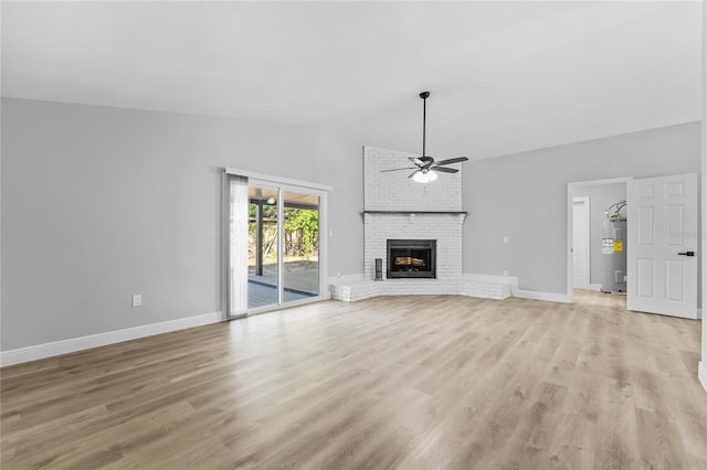 unfurnished living room with light hardwood / wood-style floors, a fireplace, ceiling fan, and lofted ceiling