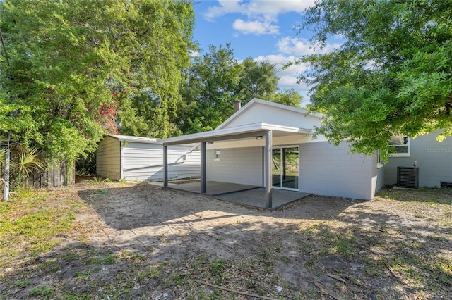 rear view of property featuring central AC unit