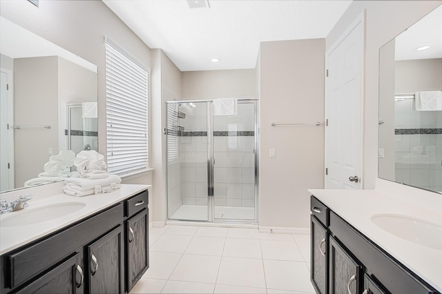 bathroom with walk in shower, tile floors, and vanity