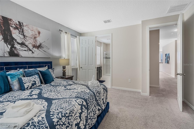 bedroom with light carpet and a textured ceiling