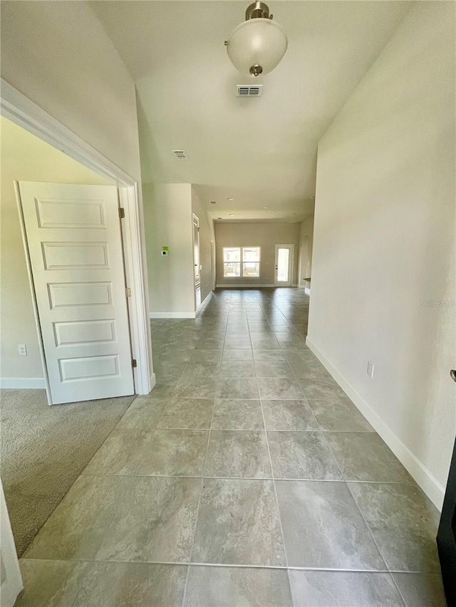 hallway featuring light tile flooring