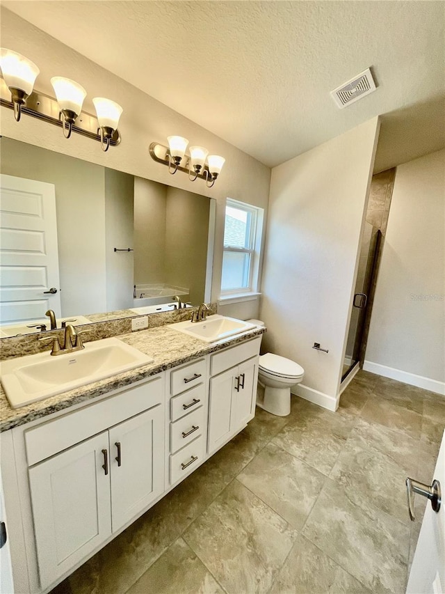 bathroom featuring double sink, tile floors, a textured ceiling, toilet, and large vanity