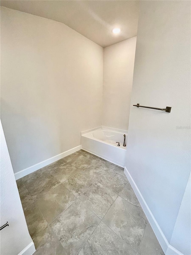 bathroom with tile floors and a bath to relax in