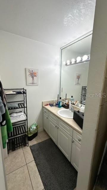 bathroom with tile floors and vanity