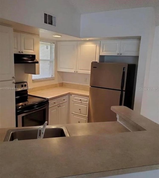 kitchen with range with electric cooktop, ventilation hood, stainless steel refrigerator, and white cabinetry