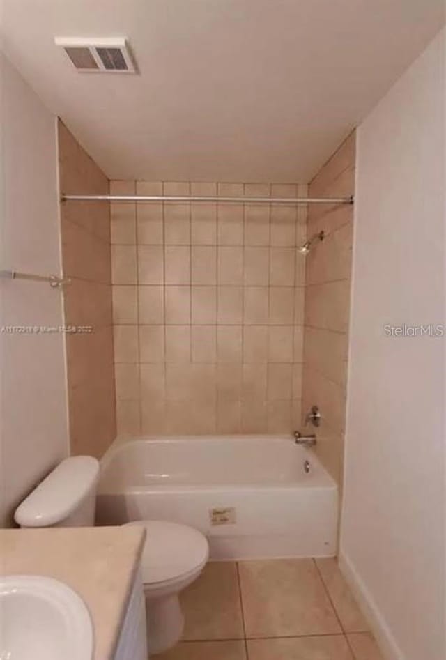 full bathroom featuring tiled shower / bath, toilet, tile flooring, and vanity