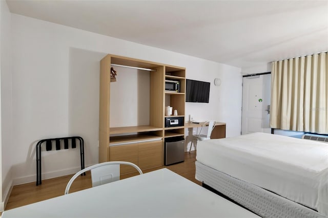 bedroom with dark wood-type flooring