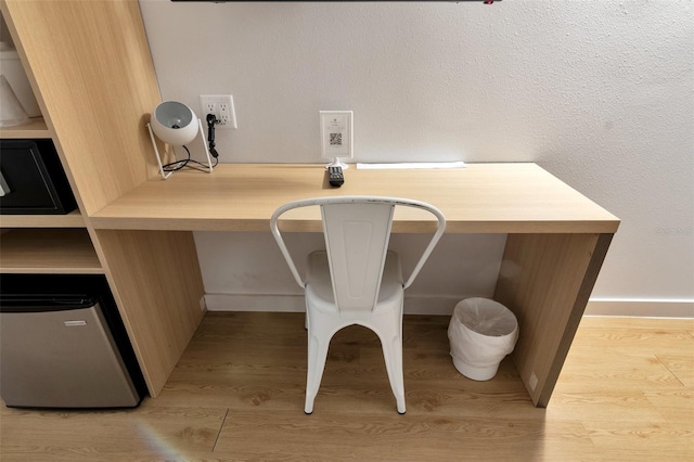 interior space featuring built in desk and light hardwood / wood-style flooring