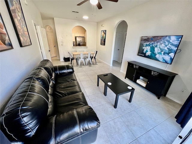 tiled living room featuring ceiling fan