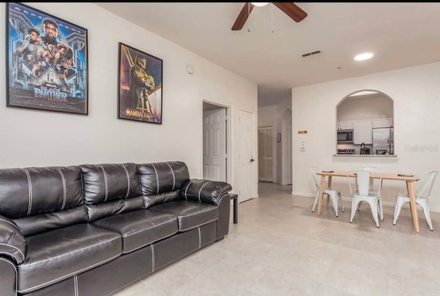 living room with ceiling fan and light tile floors