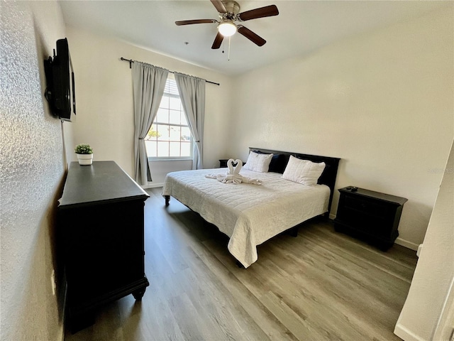 bedroom featuring wood-type flooring and ceiling fan