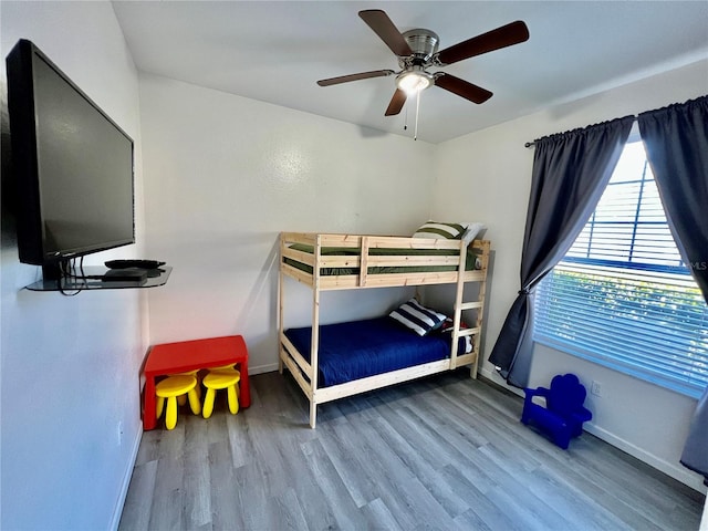 bedroom with wood-type flooring and ceiling fan