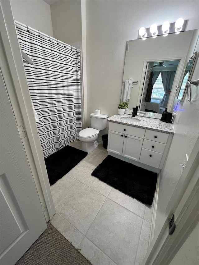 bathroom featuring tile flooring, large vanity, ceiling fan, and toilet