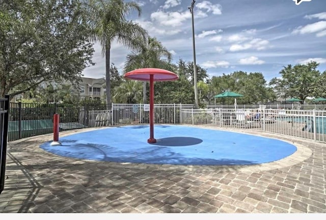 view of basketball court with a community pool