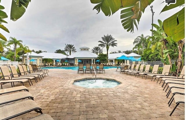 view of swimming pool with a patio, a gazebo, and a hot tub