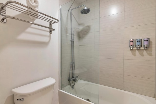 bathroom with toilet and tiled shower / bath combo