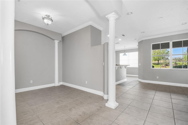 tiled empty room with crown molding and decorative columns