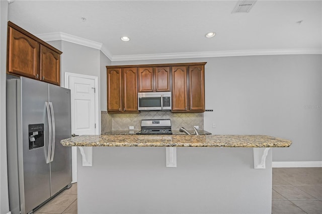 kitchen with backsplash, stainless steel appliances, light tile floors, light stone counters, and crown molding