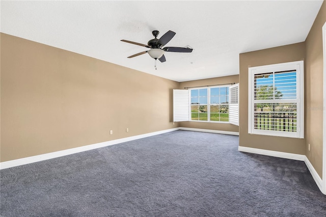 carpeted spare room featuring ceiling fan