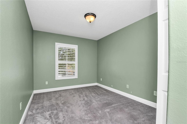 carpeted spare room featuring a textured ceiling