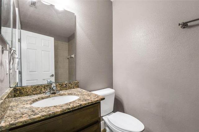 bathroom with toilet and vanity