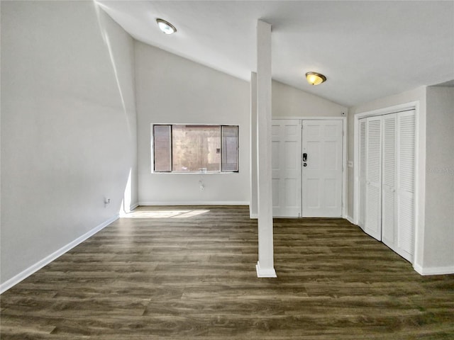 entrance foyer featuring vaulted ceiling and dark wood-type flooring