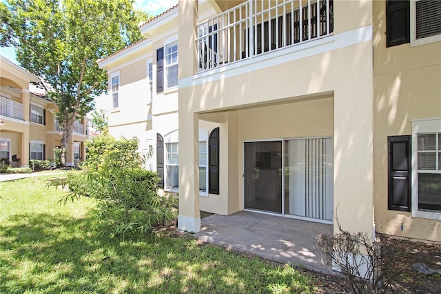 entrance to property with a lawn