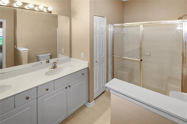 bathroom featuring vanity, toilet, and a shower with door