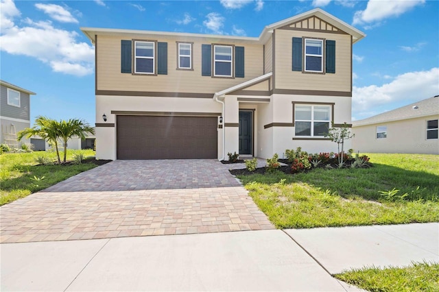 view of front of property featuring a garage and a front lawn