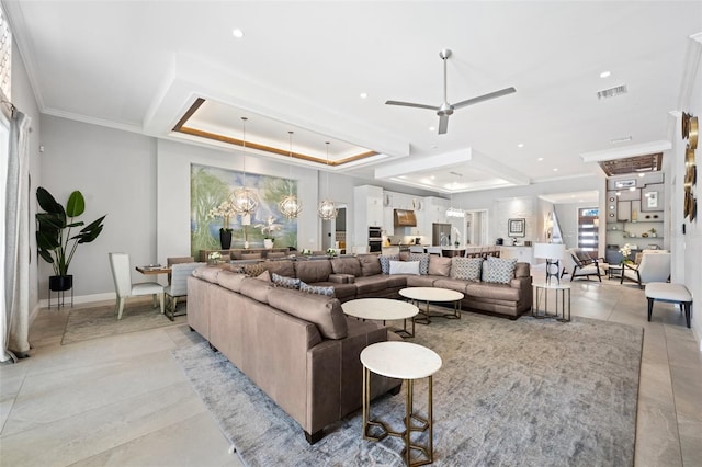 living room featuring crown molding, light tile flooring, ceiling fan with notable chandelier, and a raised ceiling