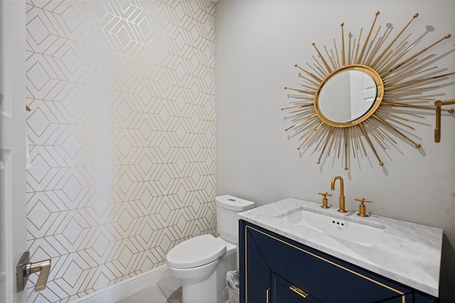 bathroom with toilet and vanity with extensive cabinet space