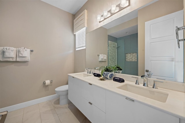 bathroom featuring toilet, tile floors, dual sinks, and large vanity