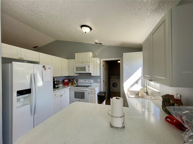 kitchen featuring white appliances, white cabinetry, and vaulted ceiling