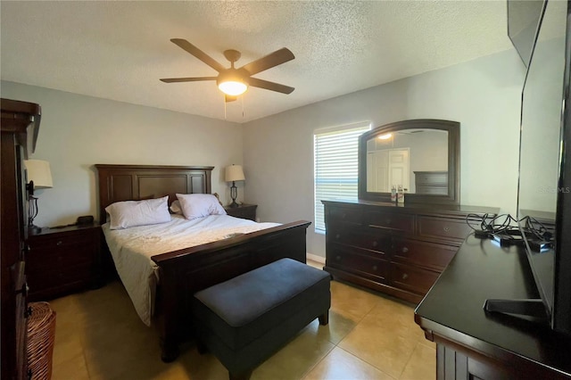 bedroom featuring light tile flooring, ceiling fan, and a textured ceiling