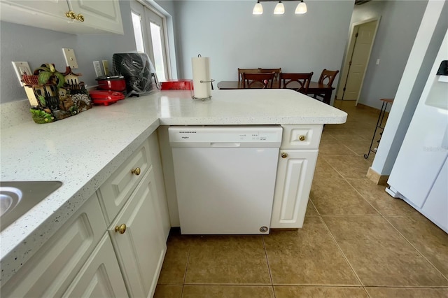 kitchen with white cabinets, light tile floors, and dishwasher