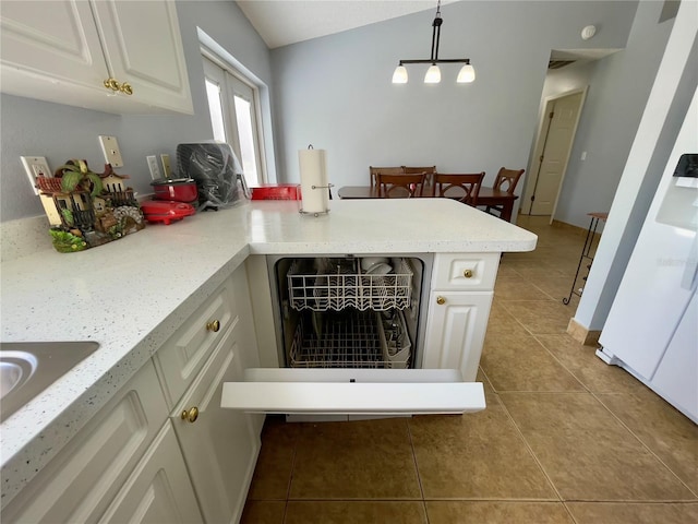 kitchen with decorative light fixtures, light tile flooring, light stone countertops, white cabinets, and lofted ceiling